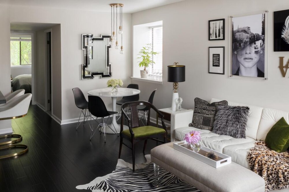 Small-Living-Dining-Area-with-zebra-hide-lucite-ottoman-tulip-table-black-and-white-neutral-apar.jpg